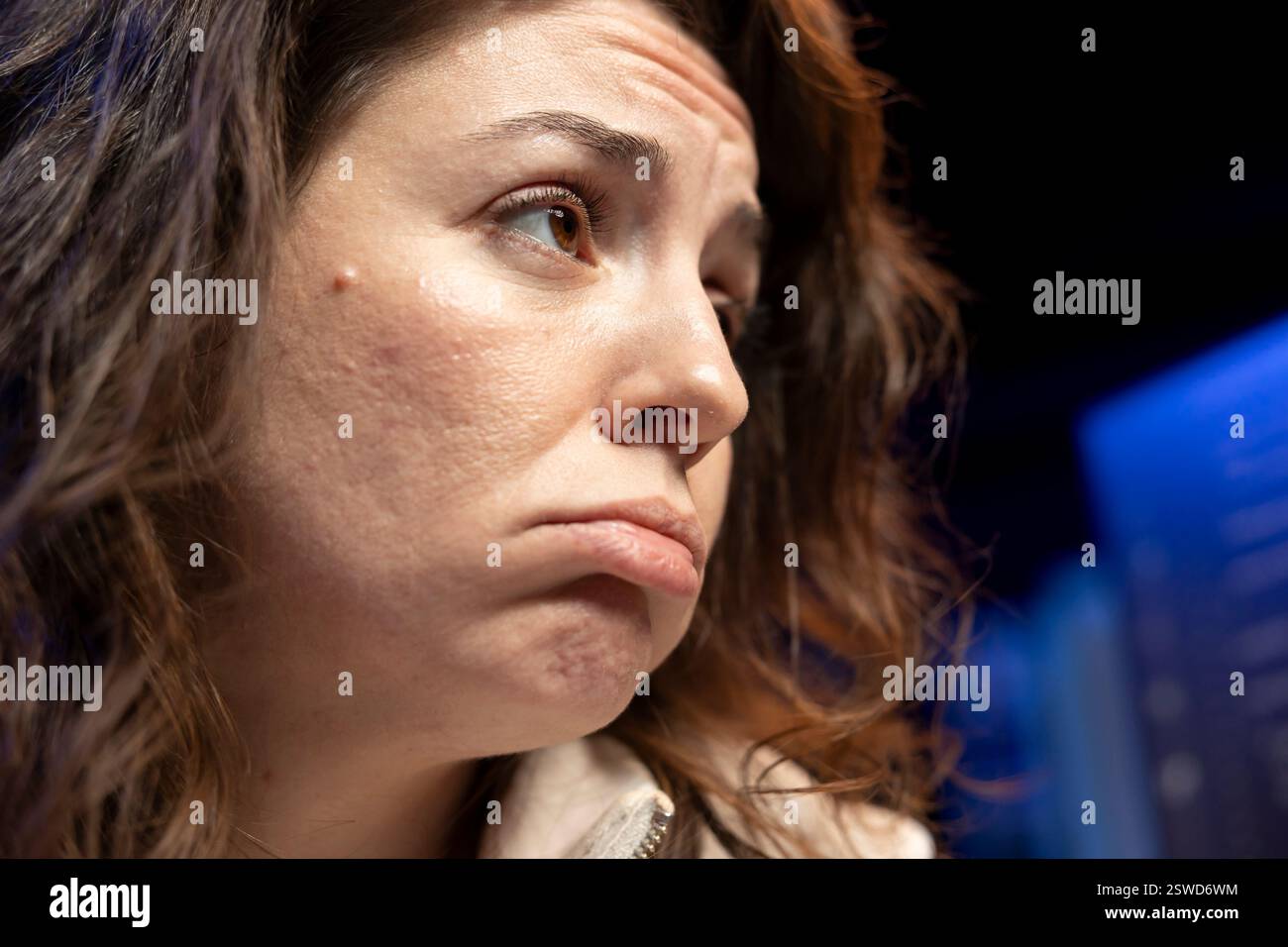 Unhappy woman sulking while doing software quality assurance, finding major errors in source code. Sad engineer upset after inspecting coding on desktop PC and seeing many issues Stock Photo