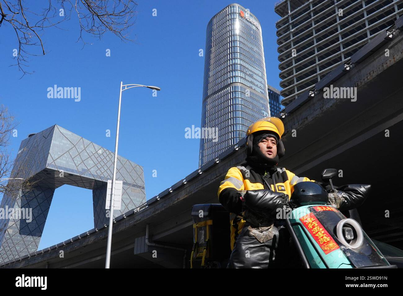 Meituan Riders Beijing,China.20th February 2025. A delivery rider for Meituan rides an ...