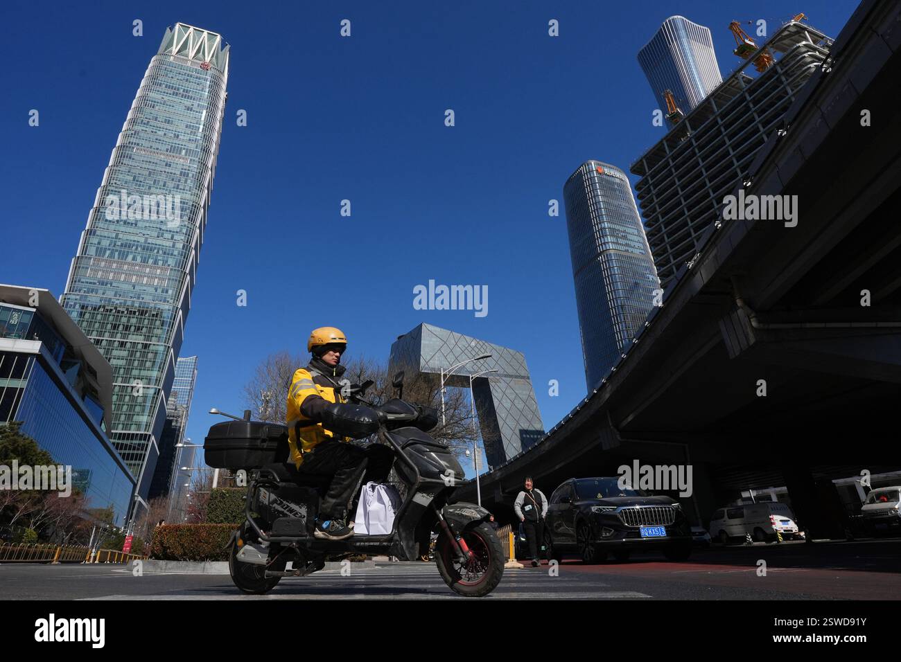 Meituan Riders Beijing,China.20th February 2025. A delivery rider for Meituan rides an ...