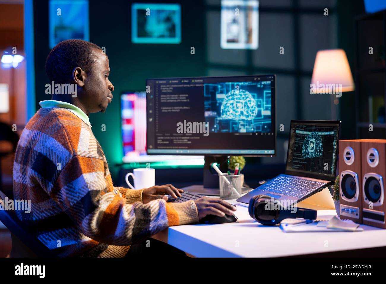 African american man working on computer to write code and programming in artificial intelligence and deep learning. Male IT engineer using pc to ensure cyber security, neural network. Stock Photo
