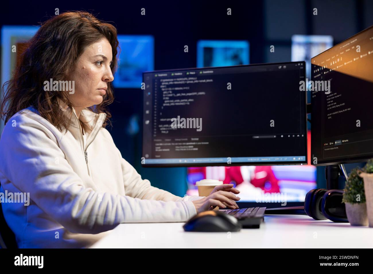System administrator fixing vulnerabilities in software enabling hackers to compromise operating system. Cybersecurity specialist in apartment using computer to patch security exposures Stock Photo
