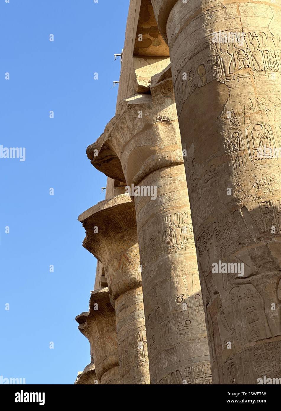 Columns in the form of papyrus stalks with bas-relief at the Great Hypostyle Hall of Karnak Temple Complex, Luxor, Egypt Stock Photo