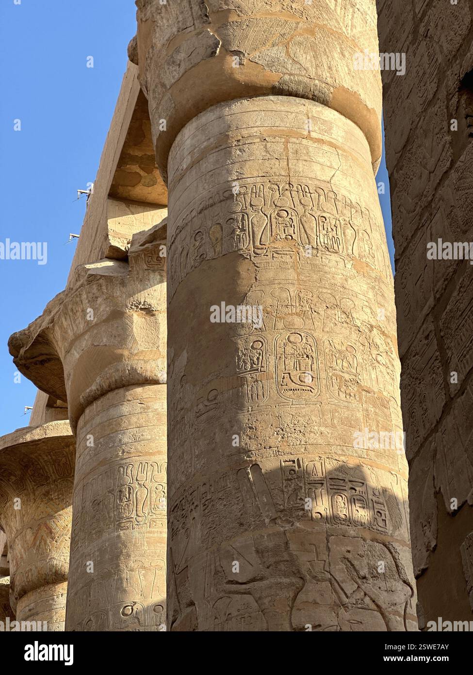 Columns in the form of papyrus stalks with bas-relief at the Great Hypostyle Hall of Karnak Temple Complex, Luxor, Egypt Stock Photo