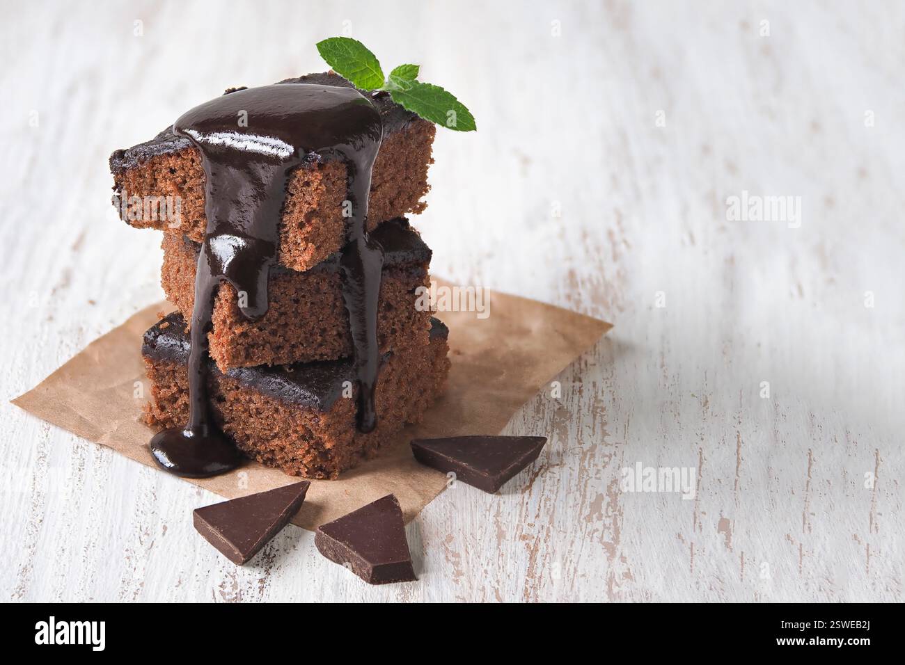 Slices of delicious brownie in a stack and poured with chocolate Stock Photo
