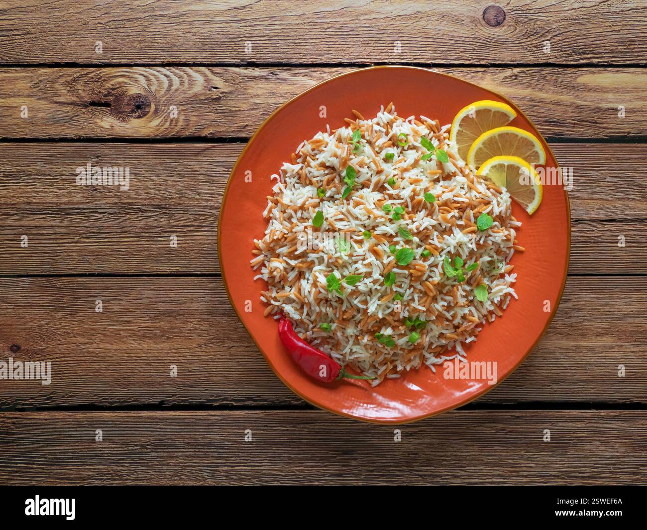 Turkish rice pilaf with orzo in a plate on a dark wooden background ...
