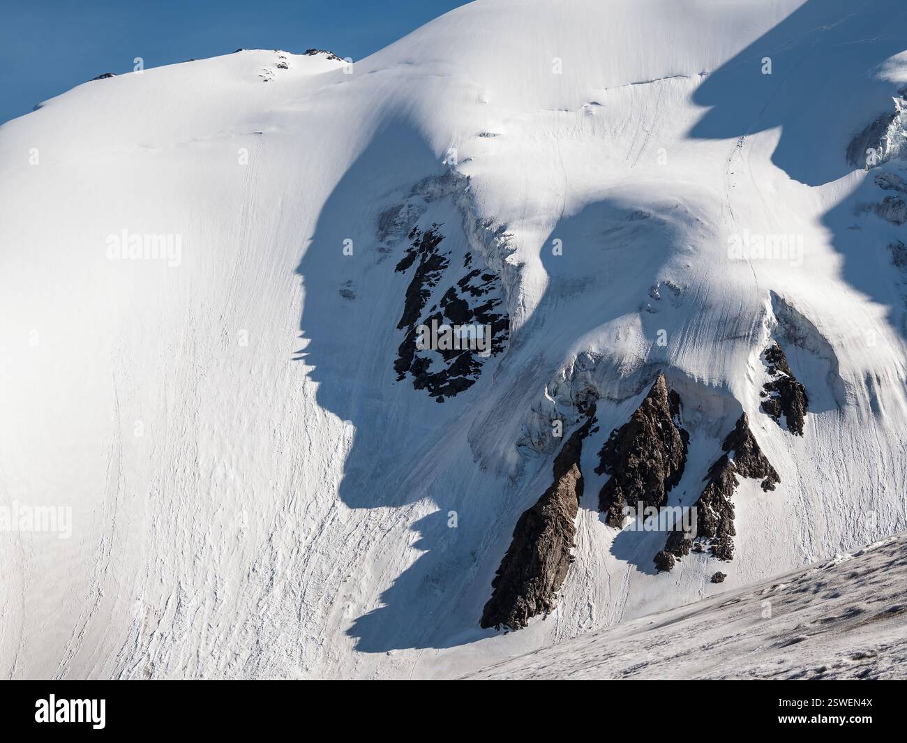 Minimalist snow mountain landscape with large glacier in sunlight ...
