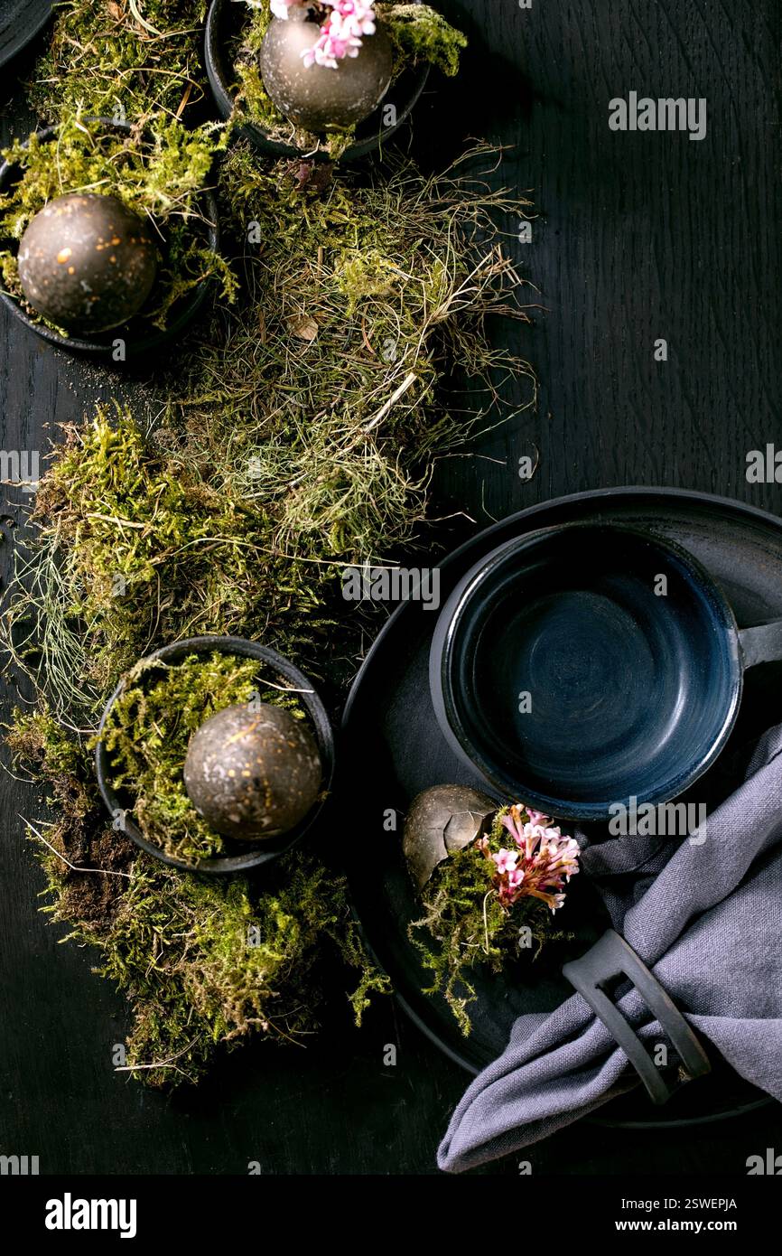 Easter table setting with empty black ceramic tableware Stock Photo