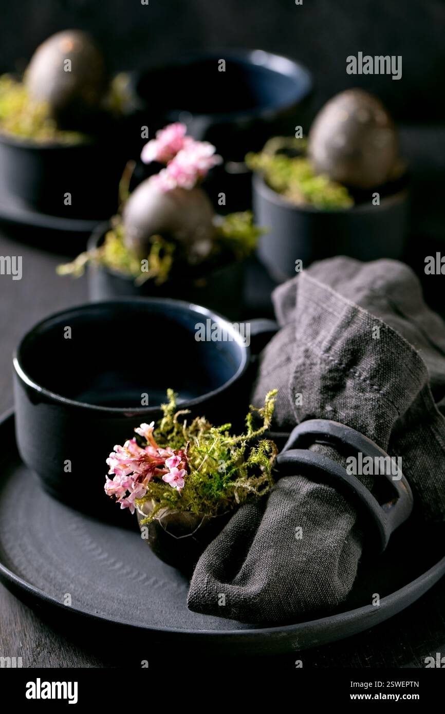 Easter table setting with empty black ceramic tableware Stock Photo