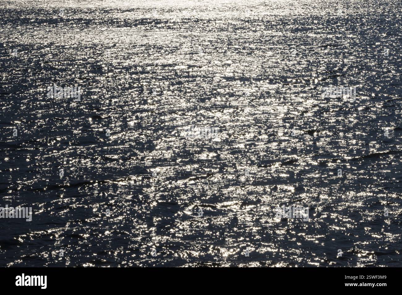 Sunbeams reflect glittering on water surface with high waves, Abstract background, Graphic elements, Mondsee, Salzkammergut, Austria, Europe Stock Photo