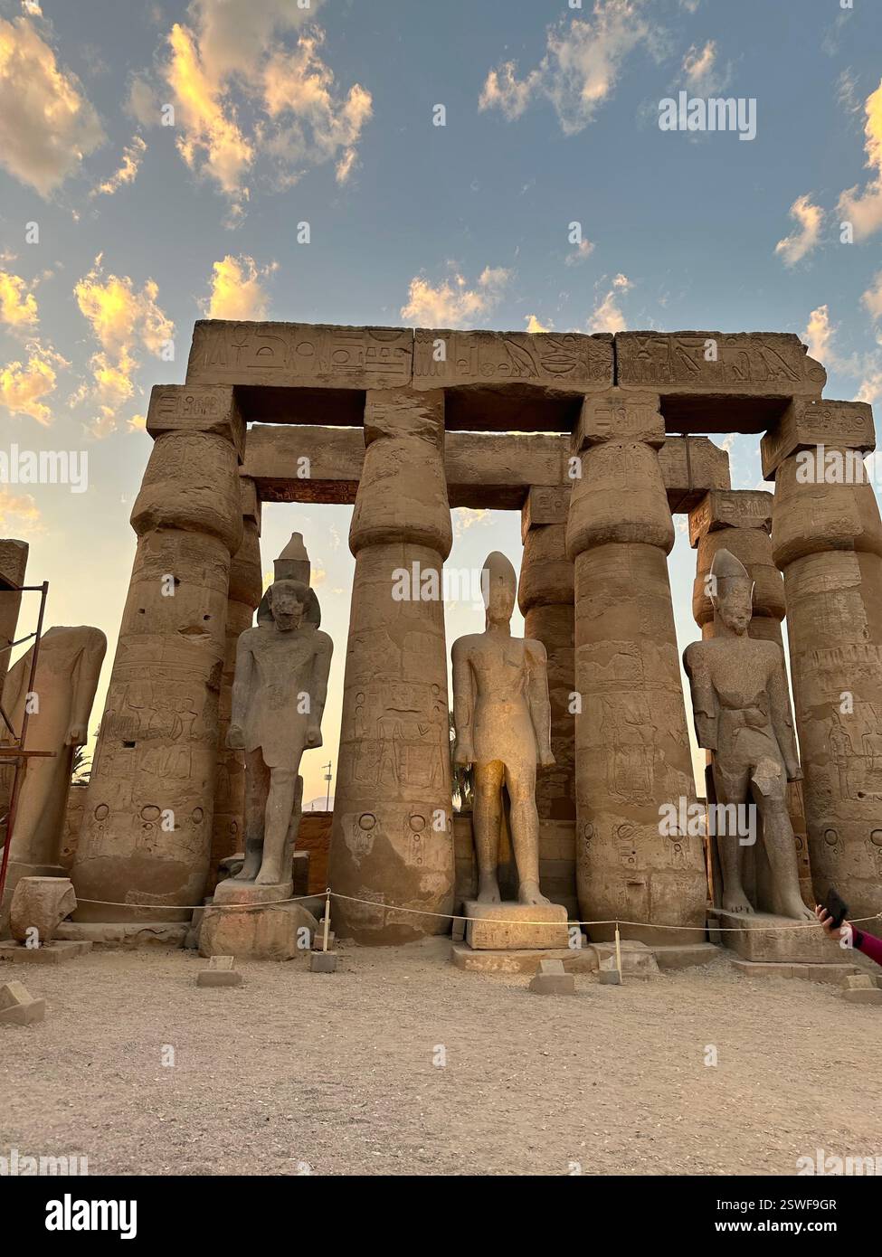Colossus of seated Ramesses II at Temple of Luxor during sunset, Egypt Stock Photo