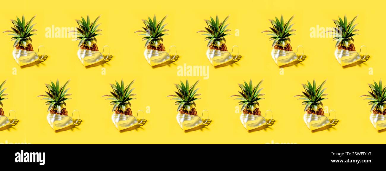 Many pineapples on a solid yellow background pattern Stock Photo