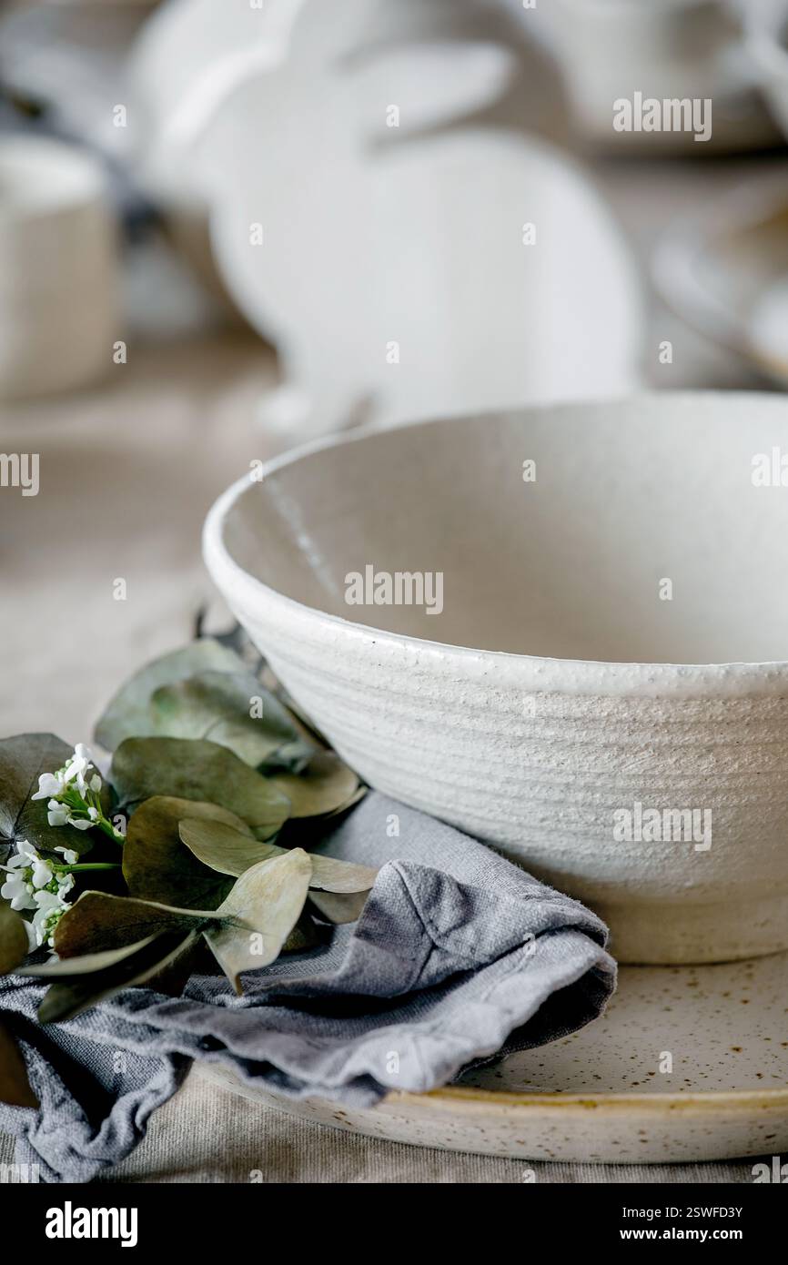 Easter dinner table setting with ceramic tableware Stock Photo