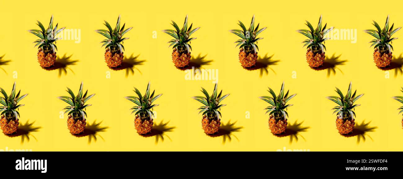 Many pineapples on a solid yellow background pattern Stock Photo
