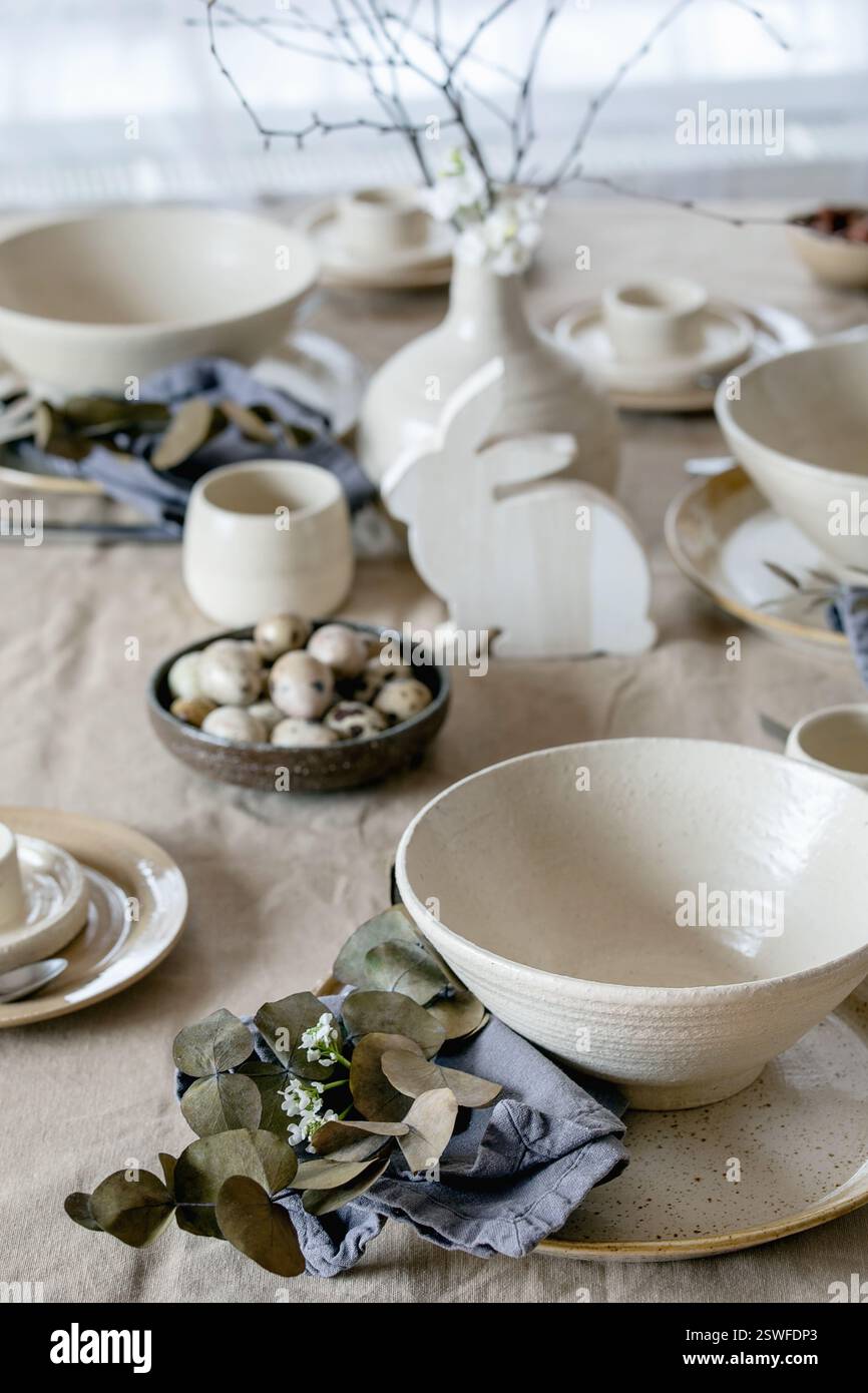 Easter dinner table setting with ceramic tableware Stock Photo