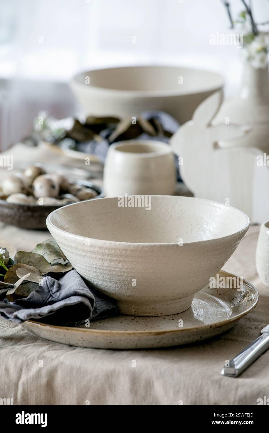 Easter dinner table setting with ceramic tableware Stock Photo