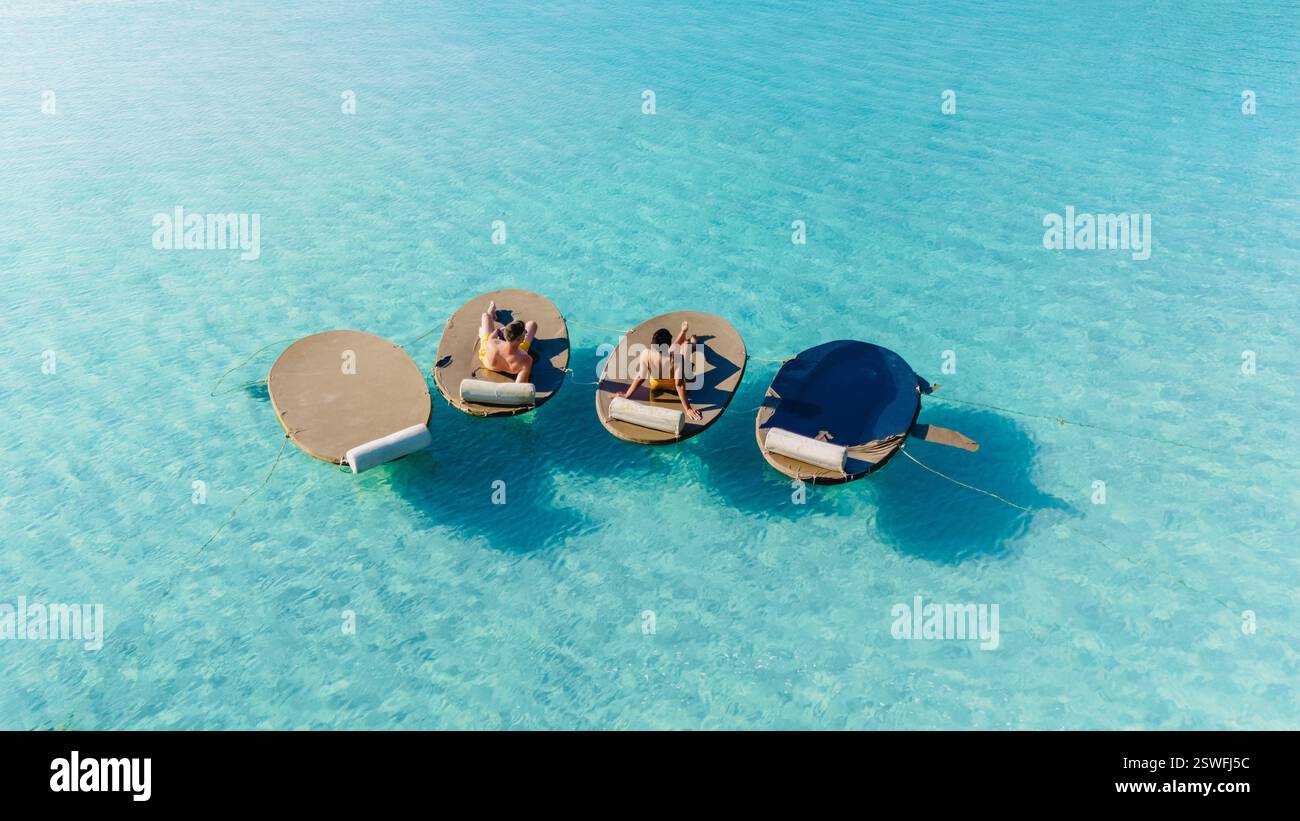 Relaxing in paradise on floating loungers in Koh Kood, Thailand Stock Photo