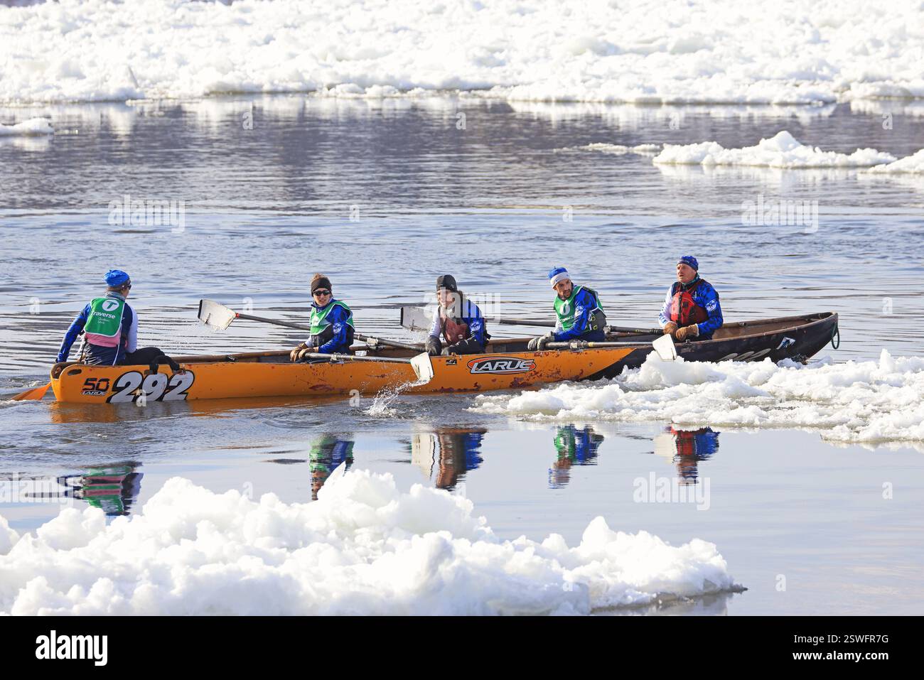 Traditional Ice Canoe Race on frozen Saint Lawrence River from Quebec to Levis during Quebec winter Carnival Stock Photo