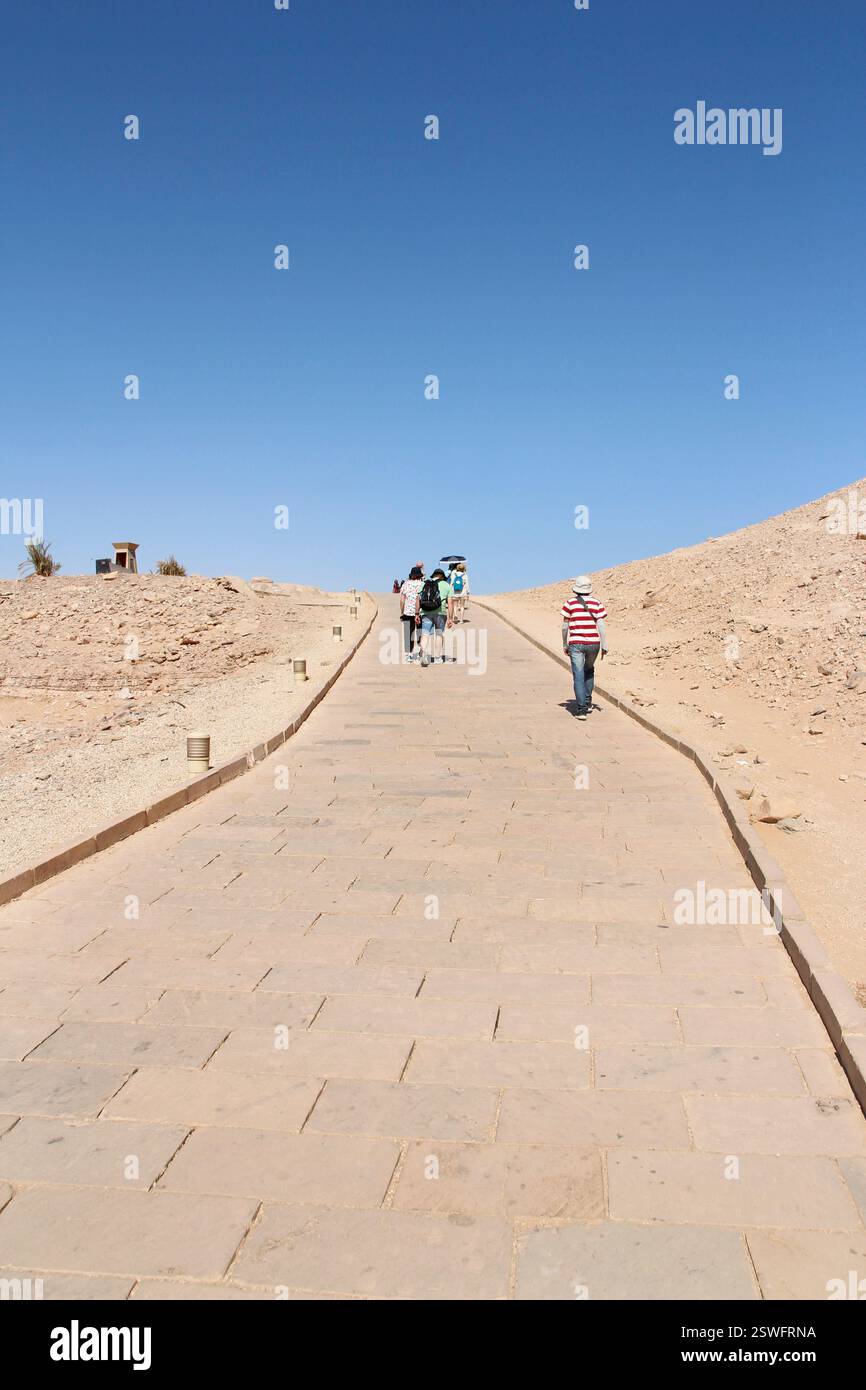 Tourists walking on the pathway to the Great Temple of Abu Simbel, Egypt Stock Photo