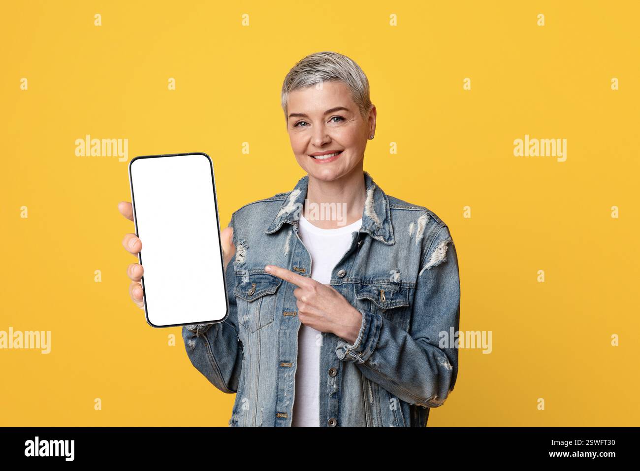 Great App. Smiling Mature Lady Pointing At Smartphone With Black Screen Stock Photo