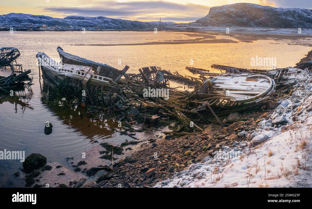 An old rusty fishing boat abandoned by a storm on the shore. Graveyard ...