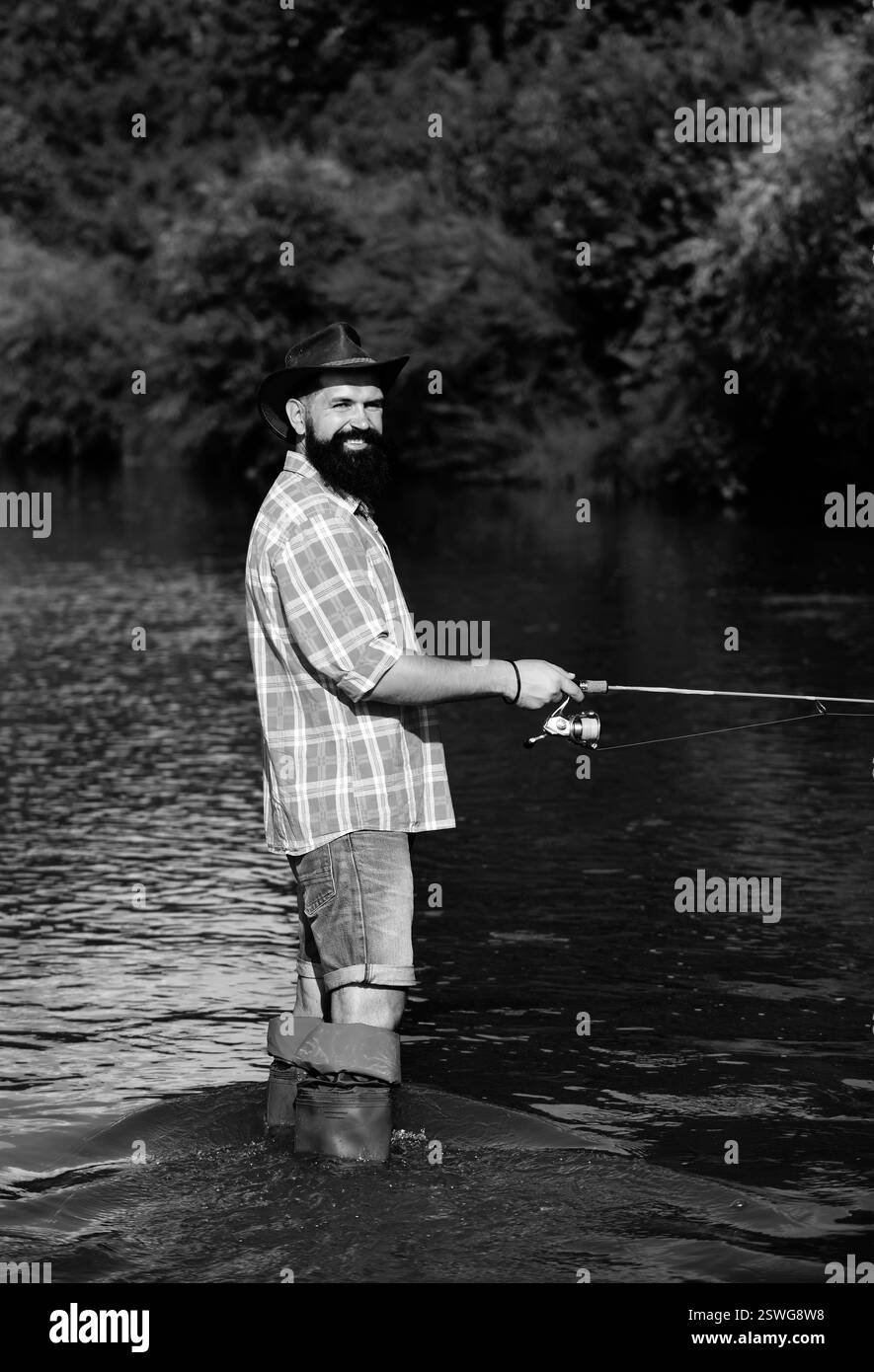 black and white man fishing with fishing pole 1950s Older Standing In Surf In Waders Holding Fish In One Hand In Other Print By Vintage Collection: Posters & Prints Fisherman with a net Black