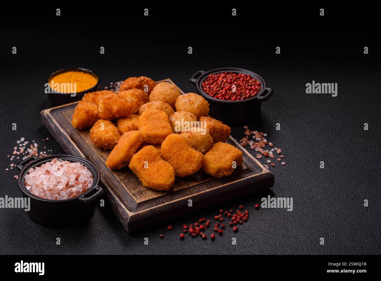 Fast food brie fries, cheese balls and chicken nuggets Stock Photo