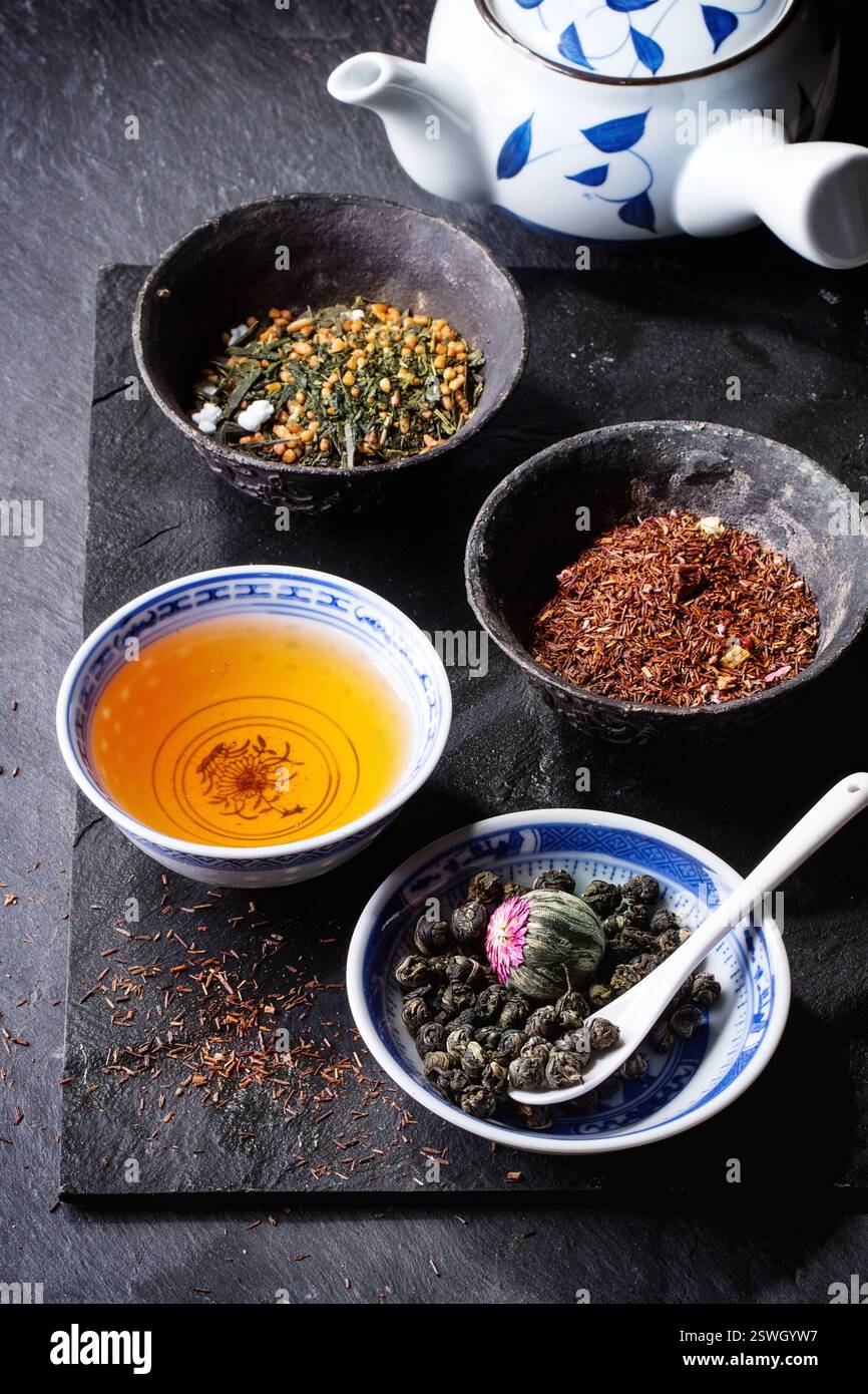 Tae Rice Assortment of dry tea, cup of hot tea and teapot. Green tea, black tae ...