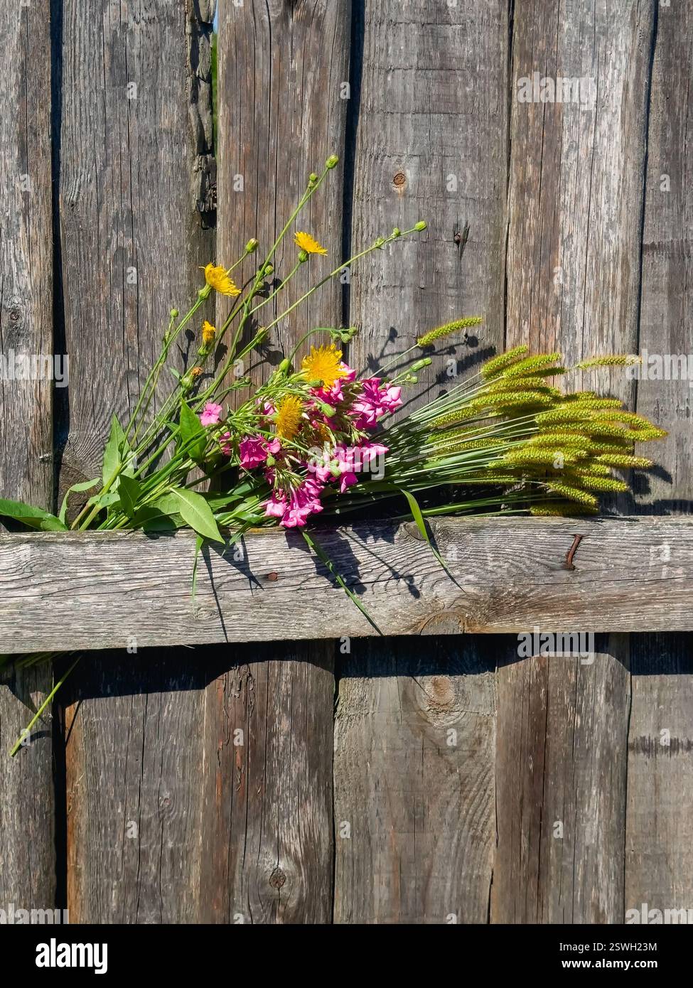 Bouquet with sunflowers in a rustic style, wooden rustic fence with ...