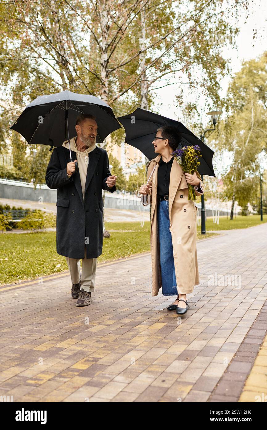 A loving couple strolls hand in hand under umbrellas, sharing laughter ...