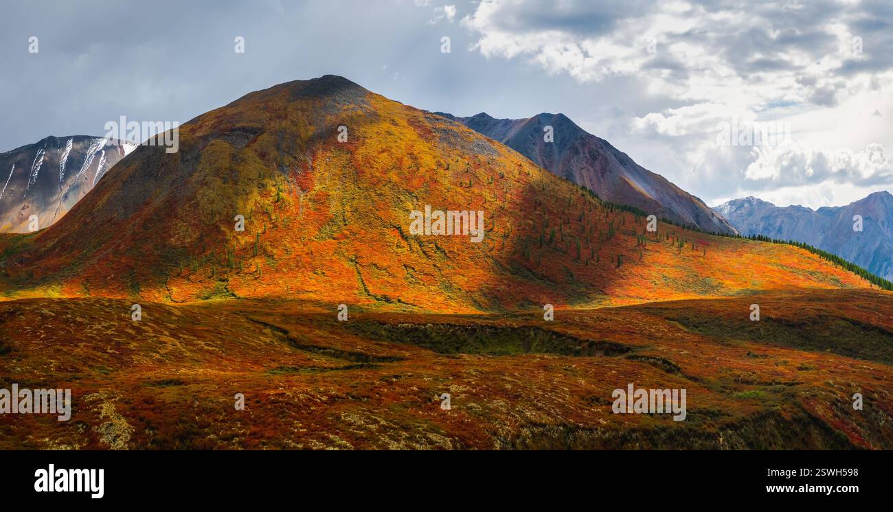 Dramatic golden light and shadow on the rock in autumn steppe. High-altitude plateau of Yeshtykol. Altai Mountains, panoramic vi Stock Photo