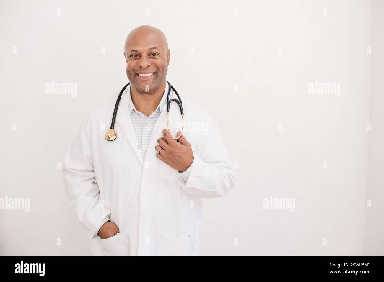 Confident and friendly doctor in a white coat with a stethoscope Stock ...
