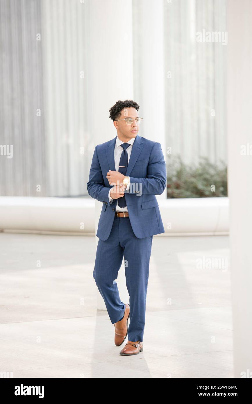Man walking in blue suit Stock Photo