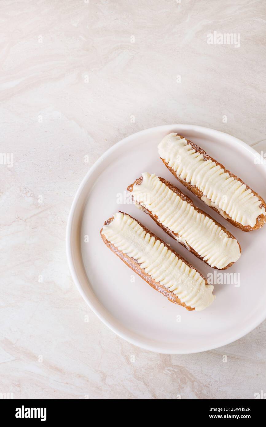 Eclairs on white marble Stock Photo