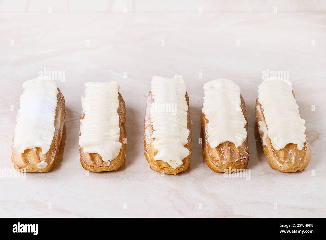 Eclairs on white marble Stock Photo
