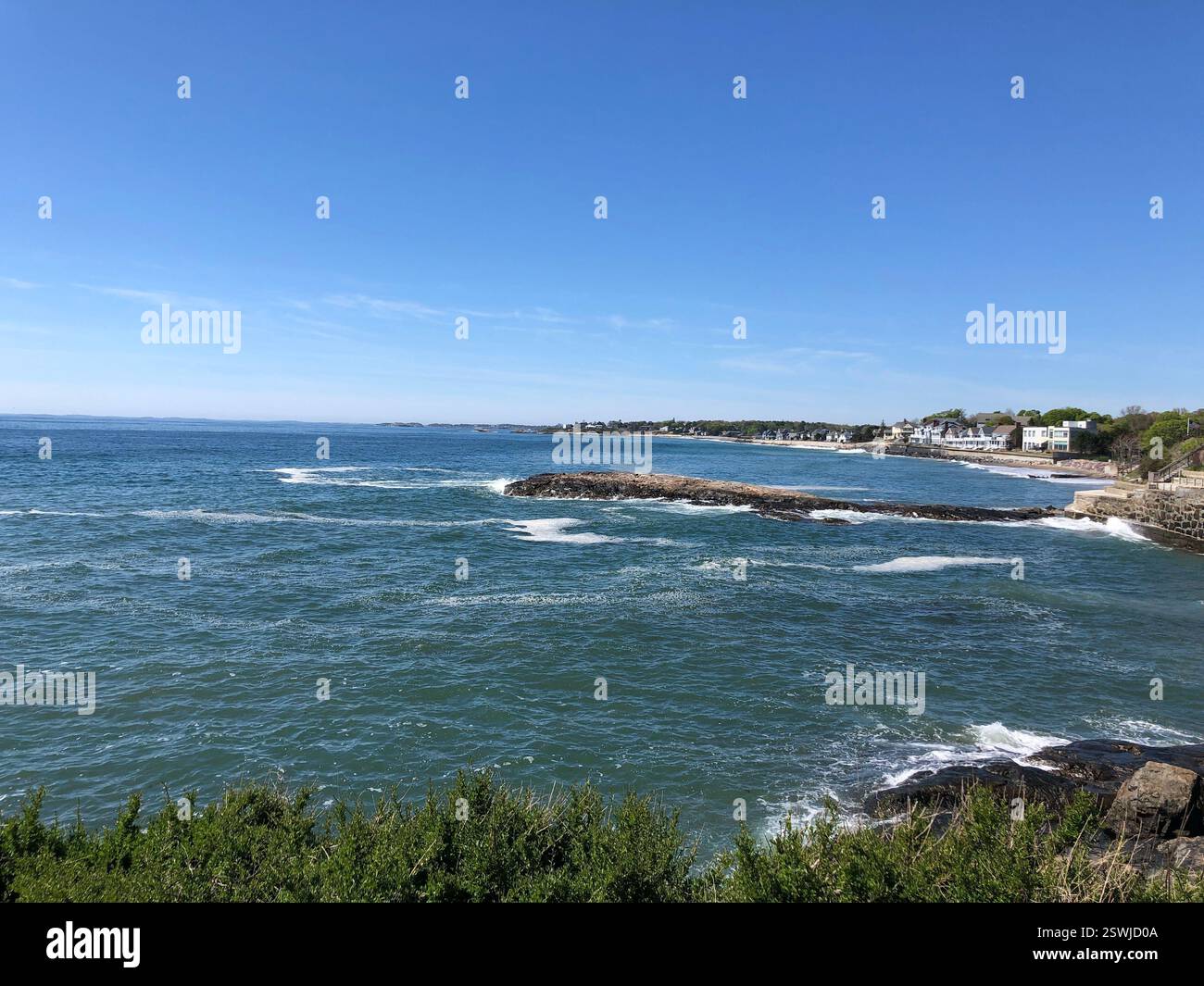 Coastal New England view from Marblehead, Massachusetts down to Swampscott, Massachusetts, with cascading waves of blue ocean waters. - Smartphone Captured Stock Image