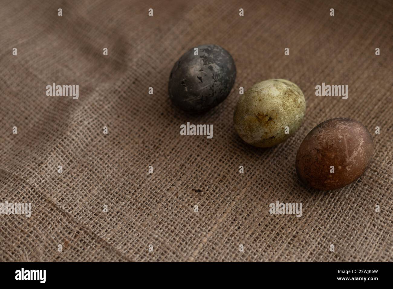 three easter eggs on a burlap texture Stock Photo