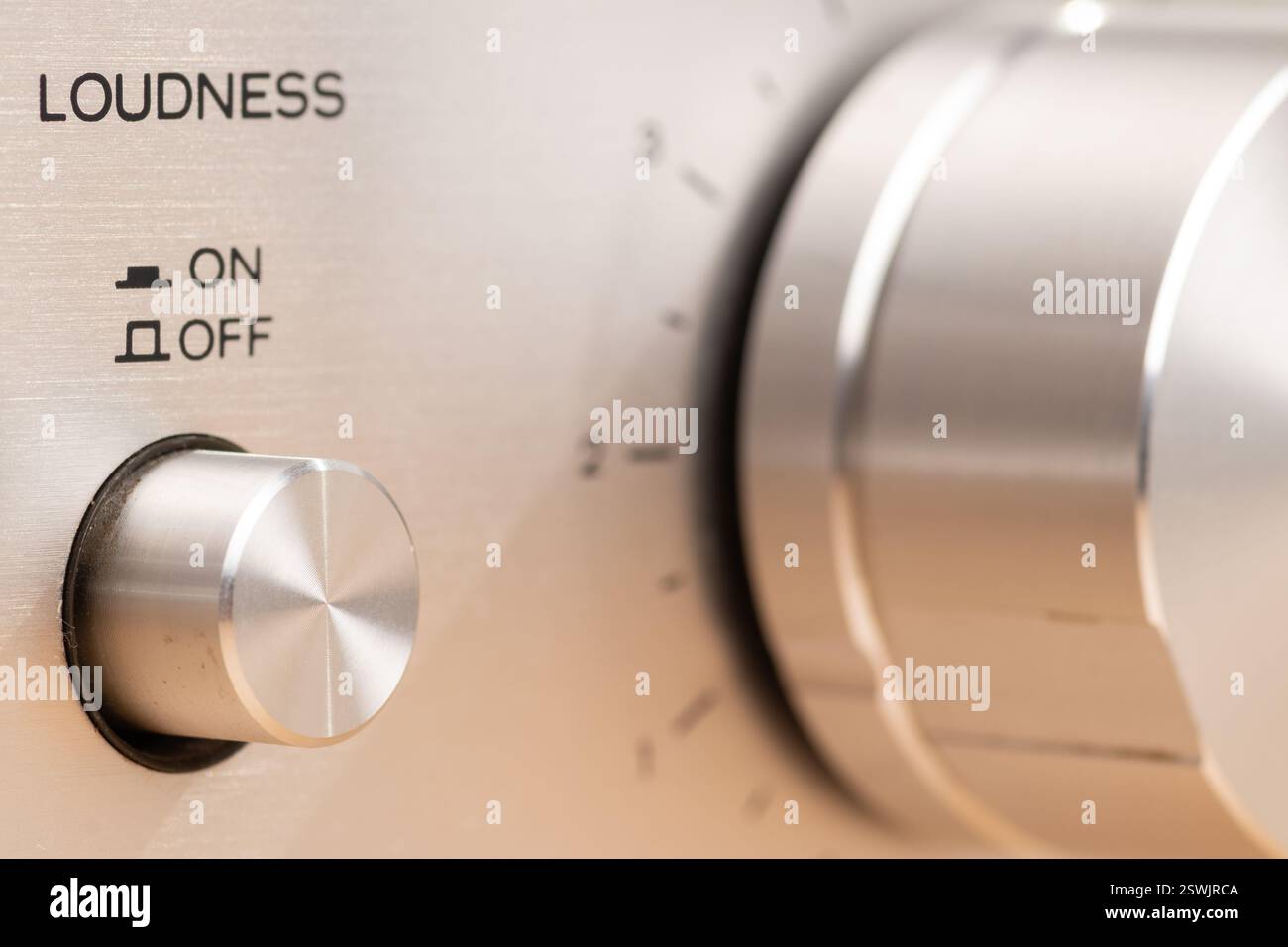 Detailed image of a close-up view of a stereo control panel featuring a rotating knob and loudness functionality, representing technical design and vo Stock Photo