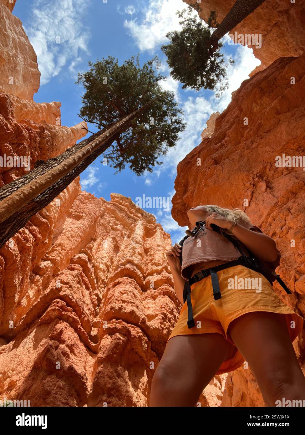 Woman hiking in desert canyon during summer with blue skies - Smartphone Captured Stock Image
