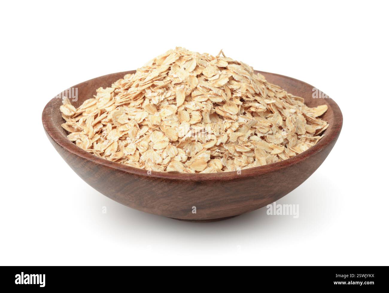 Dry rolled oatmeal in wooden plate isolated on white Stock Photo