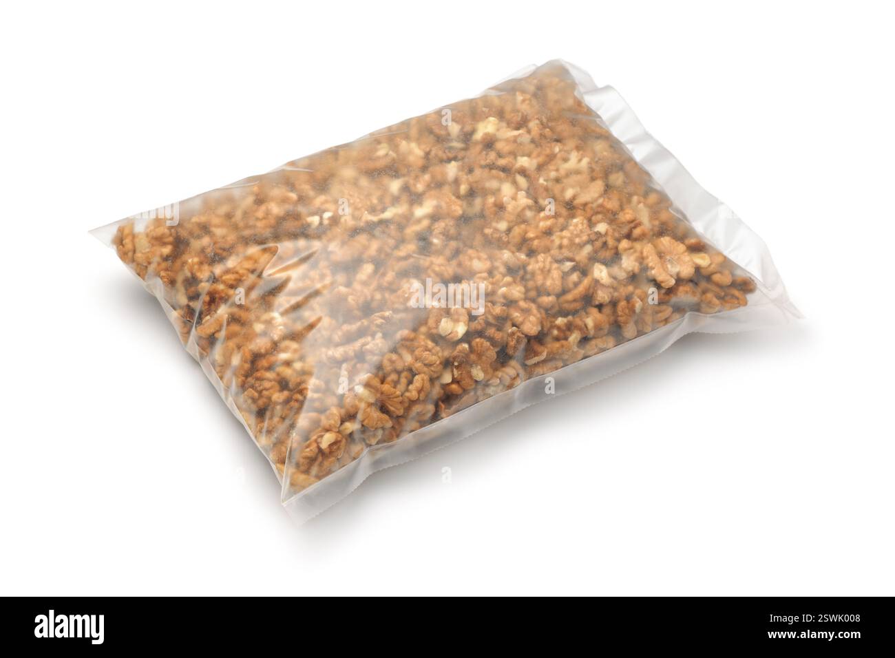 Peeled walnut kernels in transparent plastic bag isolated on white Stock Photo