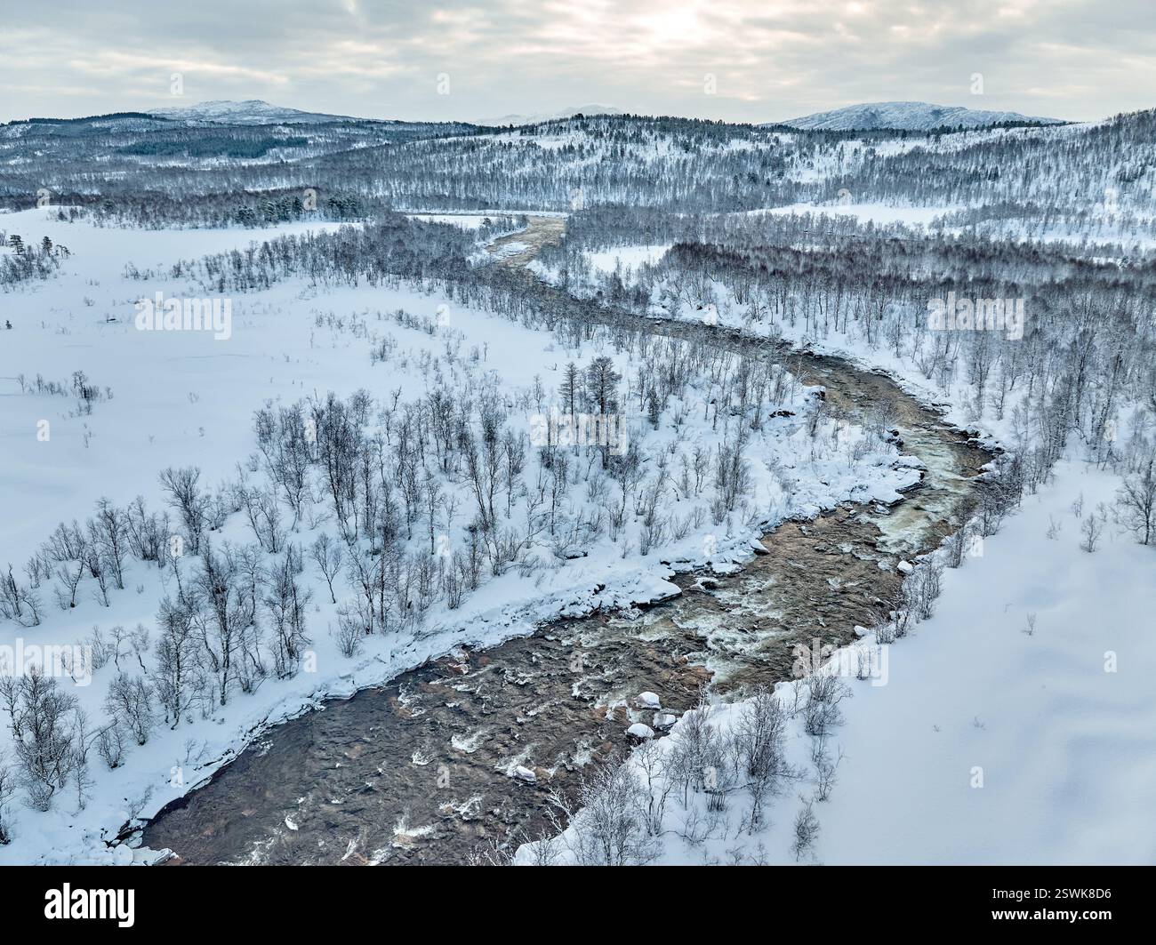 Highland Rivers aerial photo of a white water river meandering through the snowy Tundra ...