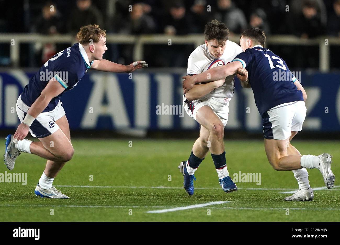 England's Angus Hall (centre) tackled by Scotland's Kerr Yule, (left ...