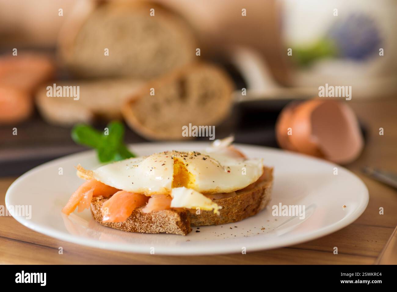 Diet breakfast with cooked egg and lightly salted red fish. Stock Photo
