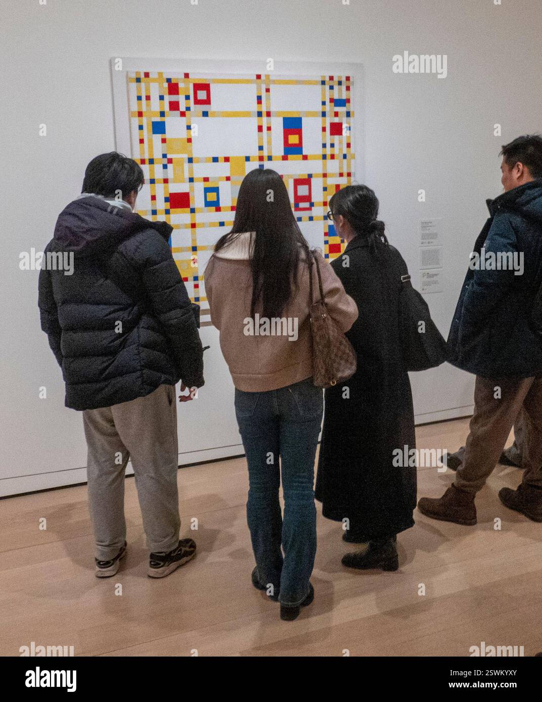 spectators in front of painting by Mondrian, Broadway Boogie Woogie, The Museum of Modern Art, New York, USA Stock Photo