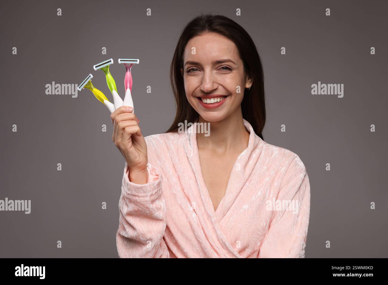 Happy woman with different razors on grey background. Hair removal ...