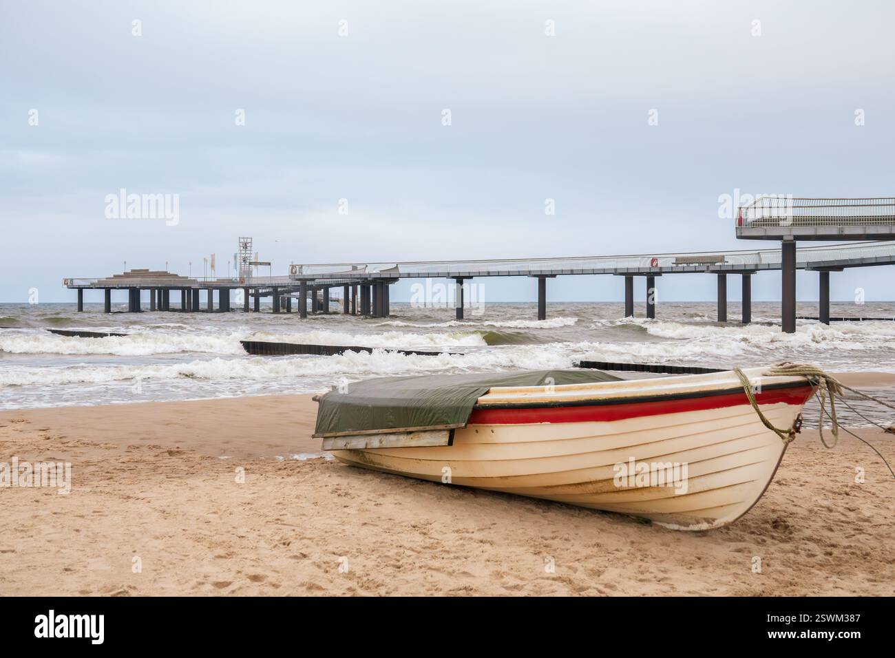 Boat on the beach in front of the Koserow pier Stock Photo - Alamy