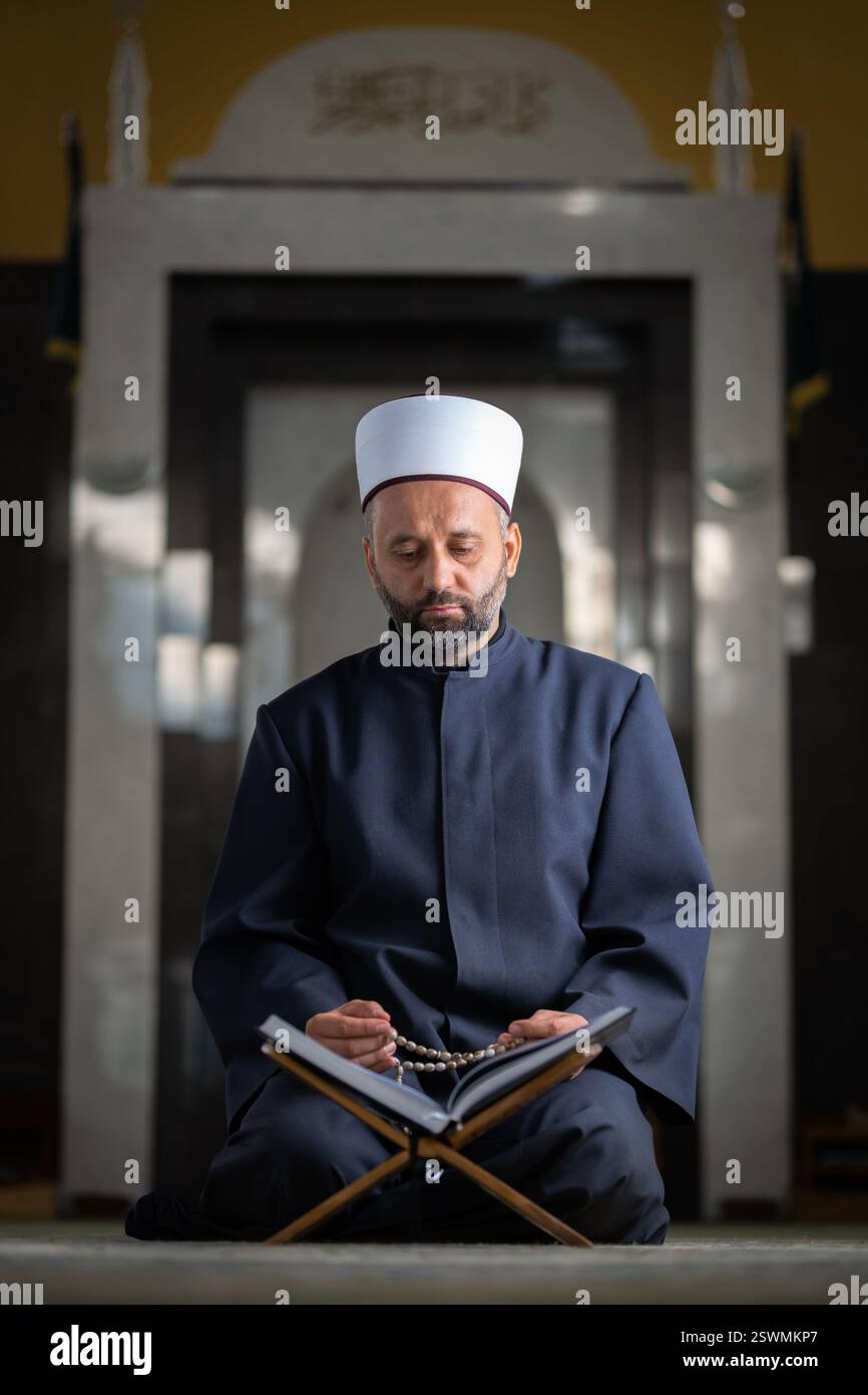 A Muslim man prayer praying inside the mosque. Stock Photo