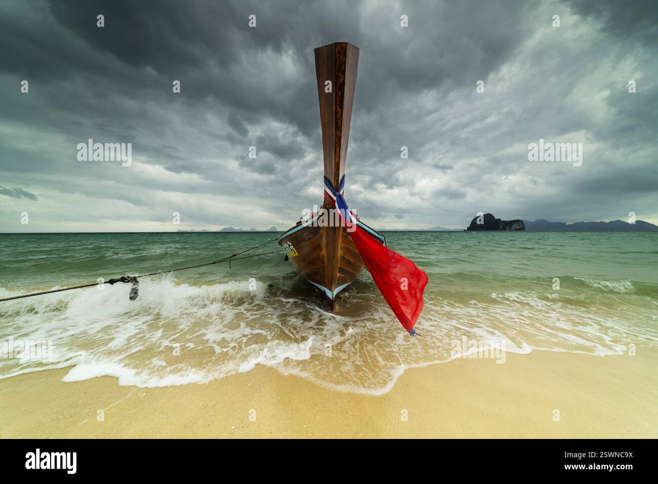Longtail boat on the beach, dark rain clouds behind, Koh Ngai Island, Andaman Sea, Satun Province, Southern Thailand, Thailand, Asia Stock Photo