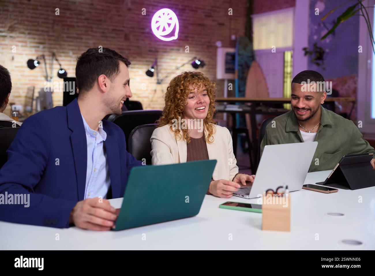 Marketing managers working with laptops in modern office Stock Photo