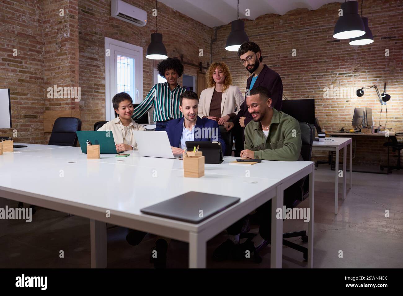 Marketing professionals collaborating on project in modern office Stock ...